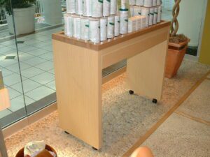 A wooden display cart with products.